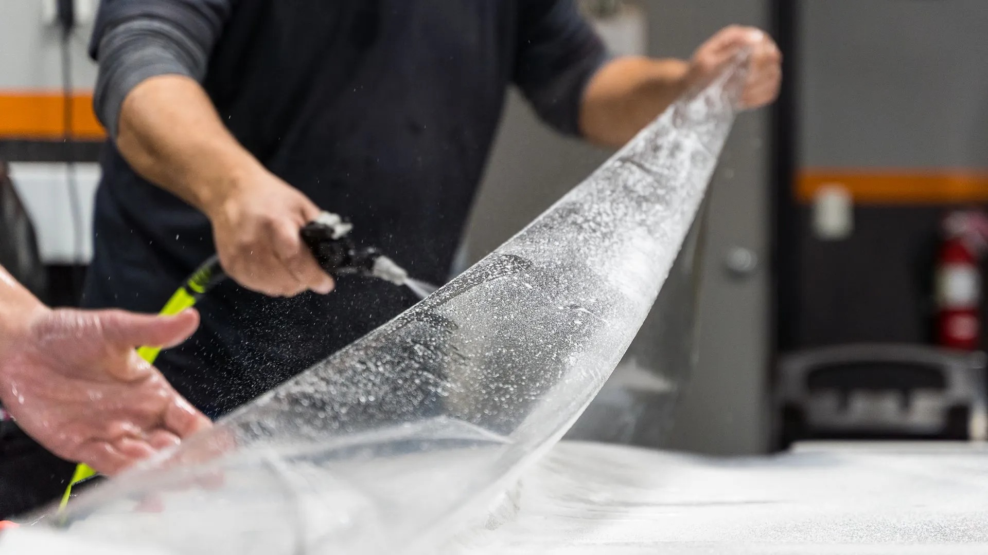 Paint Protection Film in Orlando, FL · vehicle hood installation with squeegee · pricing page